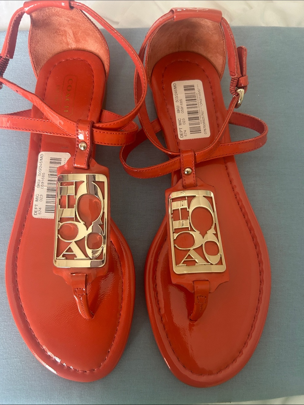 Coach Deep Coral Patent Leather Thong Sandals with Gold Logo Plaque